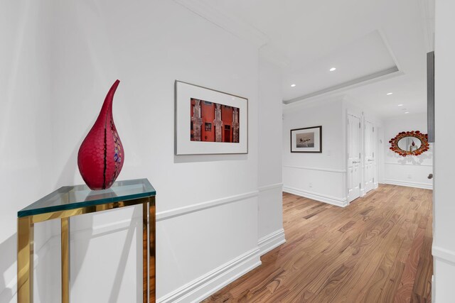 hallway with baseboards, wood finished floors, and recessed lighting