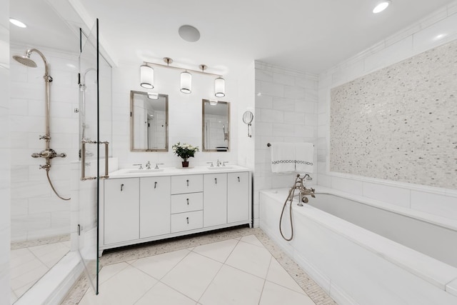 bathroom with a stall shower, a garden tub, a sink, and double vanity