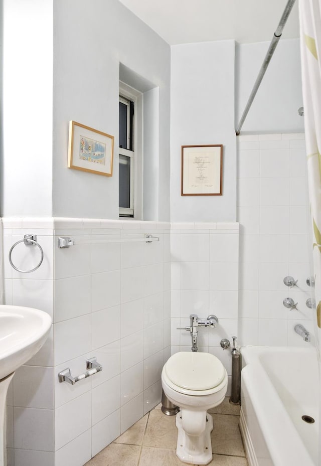 full bathroom with shower / tub combo with curtain, tile patterned flooring, toilet, and tile walls