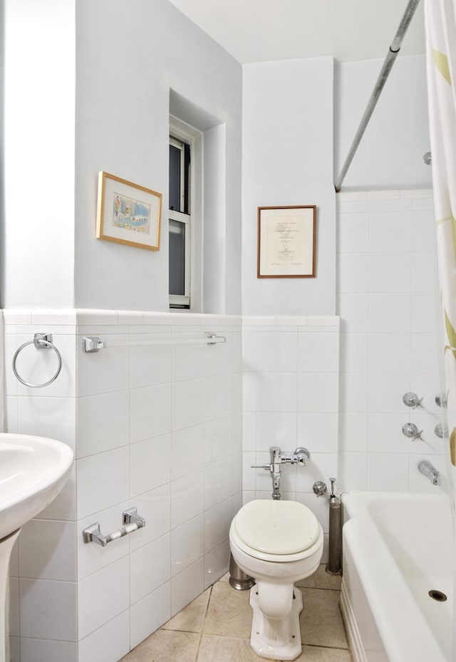 538 E 84th St Unit 2C, New York City, NY 10028 - bathroom with tile walls, shower / bath combo with shower curtain, tile patterned flooring, and a wainscoted wall