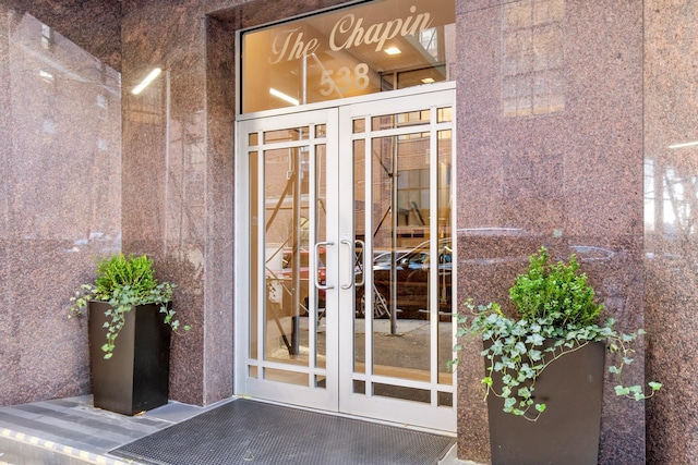 property entrance featuring french doors and stucco siding