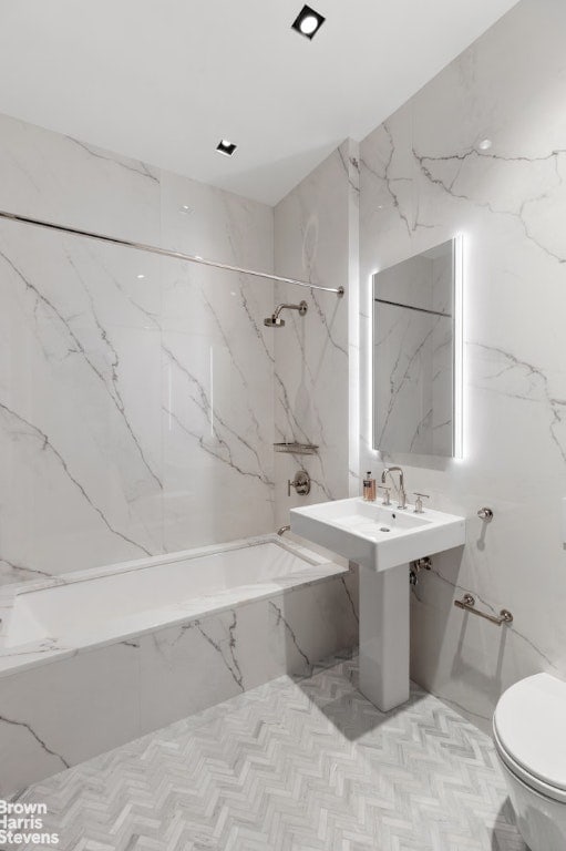 bathroom featuring toilet and tiled shower / bath