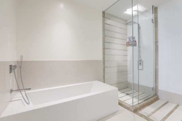 bathroom featuring separate shower and tub and tile patterned flooring