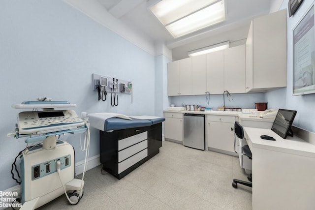 kitchen with washer / clothes dryer, sink, stainless steel dishwasher, and white cabinets