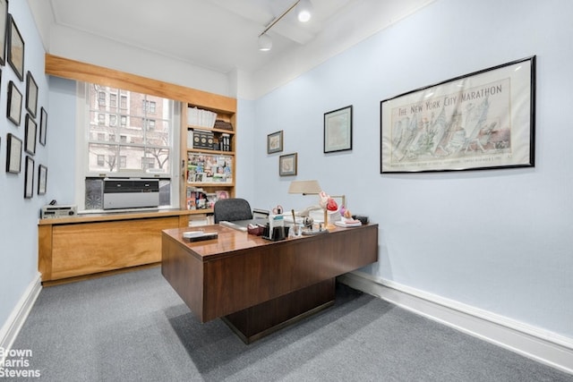 carpeted home office with track lighting