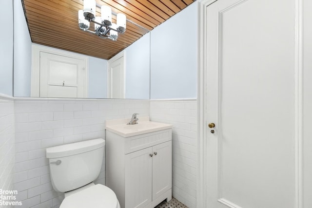 bathroom with vanity, wood ceiling, tile walls, and toilet