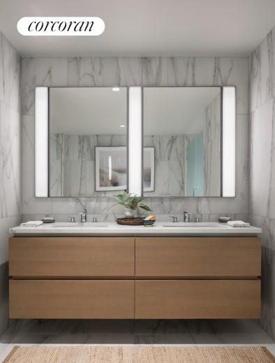 bathroom with vanity and tile walls