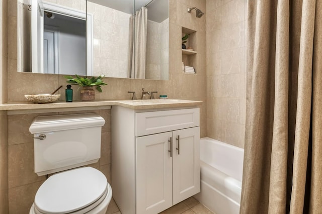 full bathroom with tile walls, shower / tub combo, tile patterned flooring, vanity, and toilet