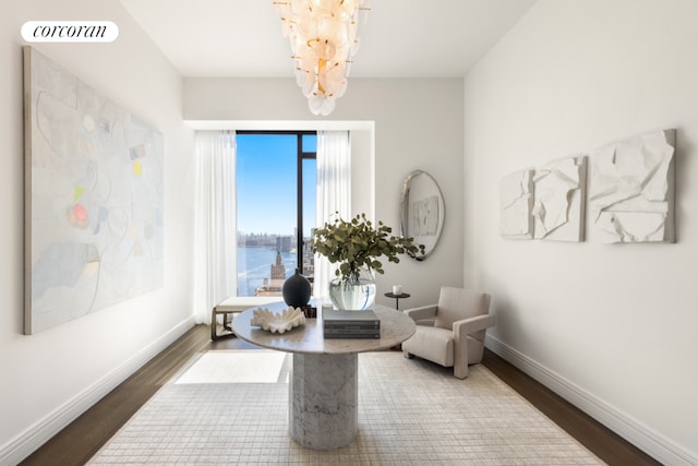 living area featuring a water view, visible vents, baseboards, and wood finished floors