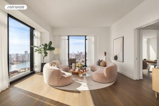 sitting room with baseboards, a view of city, visible vents, and dark wood finished floors