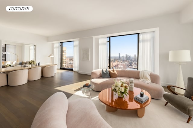 living room with a view of city, dark wood finished floors, visible vents, and baseboards