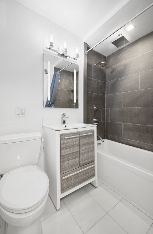 bedroom with light wood-type flooring, track lighting, an AC wall unit, and baseboard heating