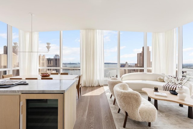 sunroom featuring wine cooler and a wealth of natural light