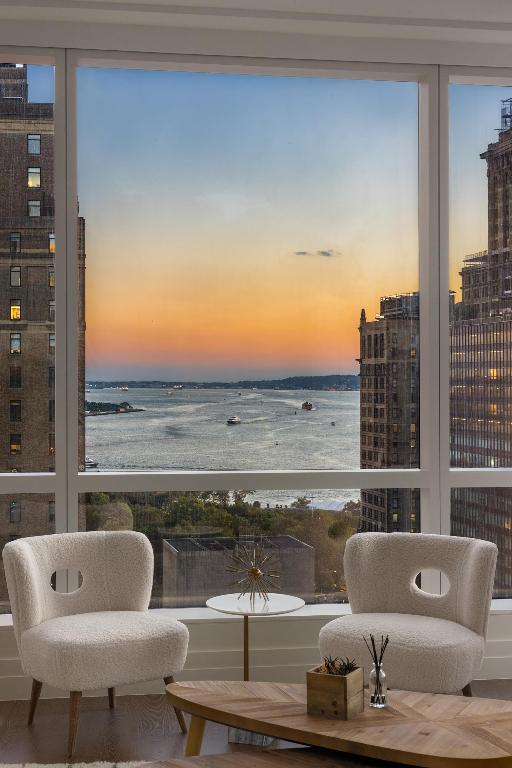 sunroom / solarium featuring a water view