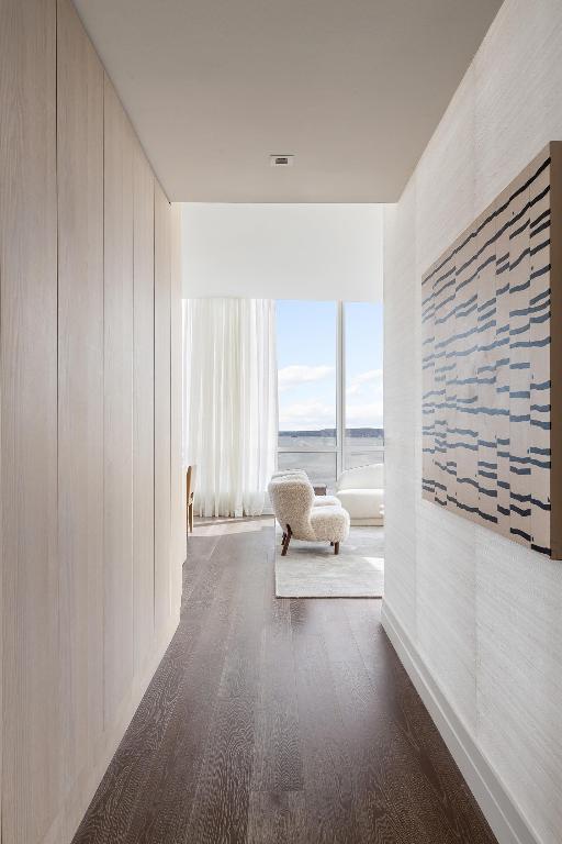 hallway featuring dark hardwood / wood-style flooring and a water view