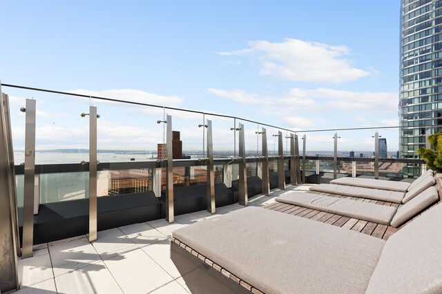 view of patio with a balcony and a water view