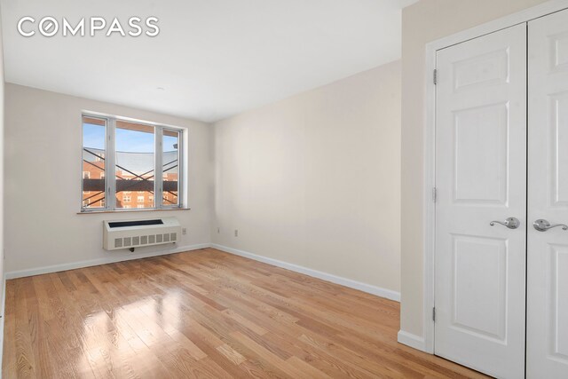 63-14 Queens Blvd Unit 7P, New York City, NY 11377 - unfurnished room featuring heating unit, baseboards, and wood finished floors