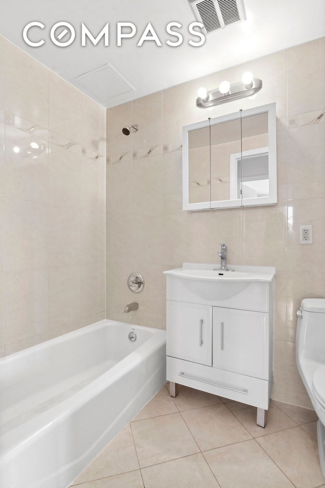 full bath featuring visible vents, toilet, tile patterned floors, tile walls, and  shower combination