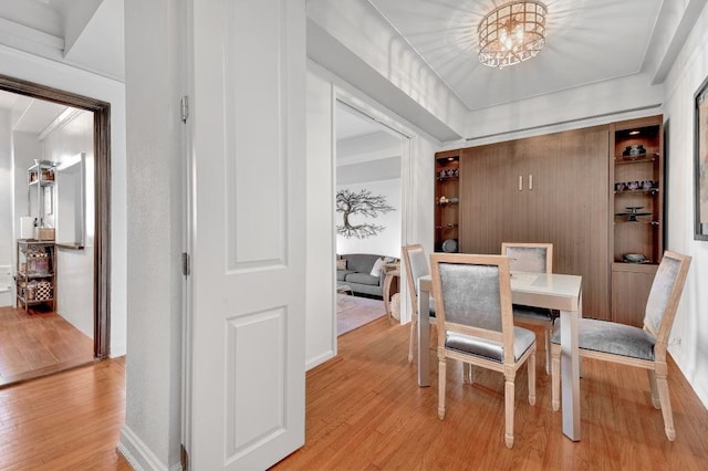 dining room with a chandelier and light wood finished floors