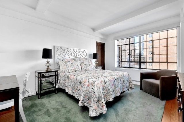 bedroom featuring beam ceiling, carpet, and baseboards