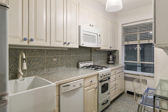 kitchen with sink, backsplash, and white appliances