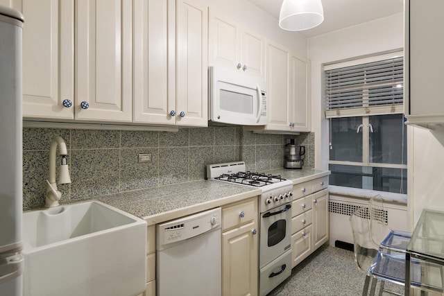 45 W 54th St Unit 8A, New York City, NY 10019 - kitchen featuring white appliances, tile counters, a sink, decorative backsplash, and radiator