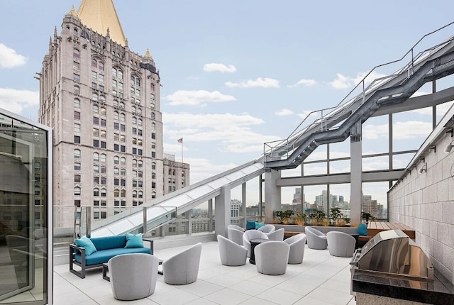 view of patio / terrace with outdoor lounge area, a grill, and a city view