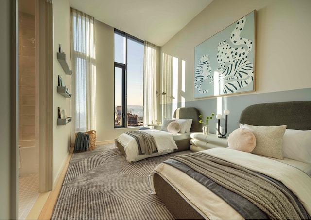 bedroom featuring a wall of windows and baseboards