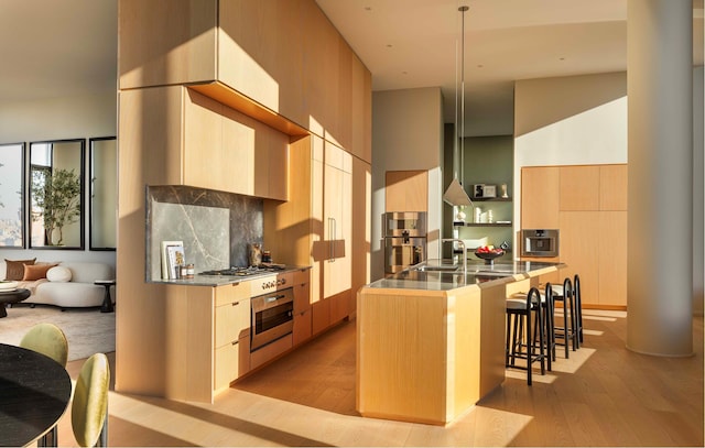 kitchen featuring a kitchen breakfast bar, modern cabinets, and stainless steel appliances