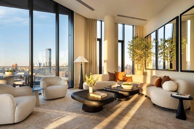 bedroom featuring a wall of windows, light hardwood / wood-style floors, and a high ceiling