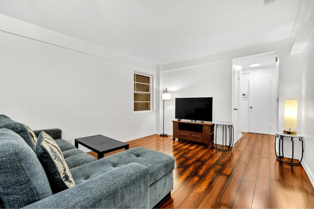 321 E 45th St Unit 8H, New York City, NY 10017 - living room with dark wood finished floors and baseboards