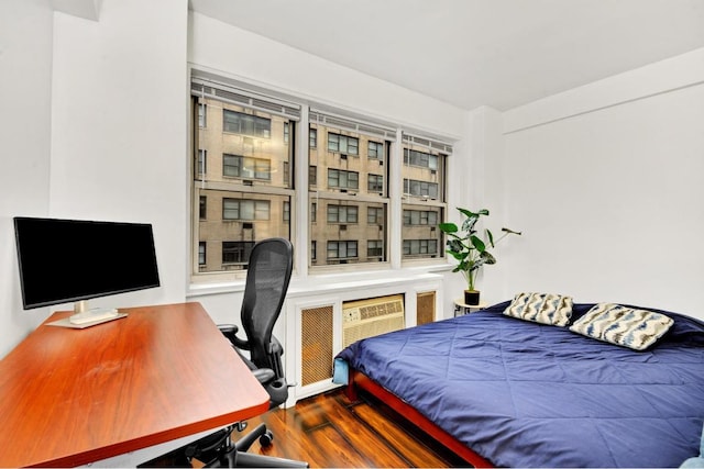 bedroom with hardwood / wood-style flooring