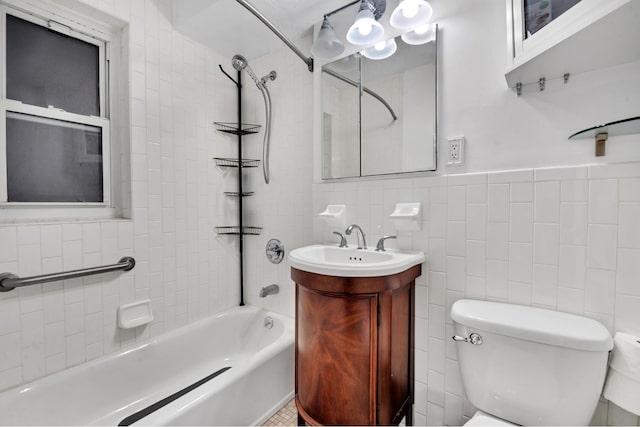 321 E 45th St Unit 8H, New York City, NY 10017 - full bath with toilet, washtub / shower combination, vanity, tile walls, and a wainscoted wall