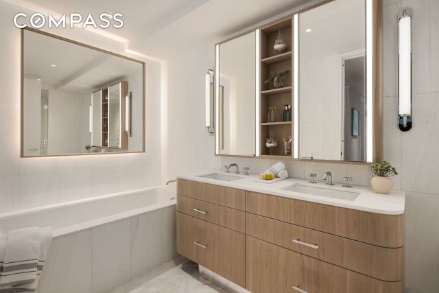 full bathroom featuring double vanity, backsplash, a garden tub, and a sink