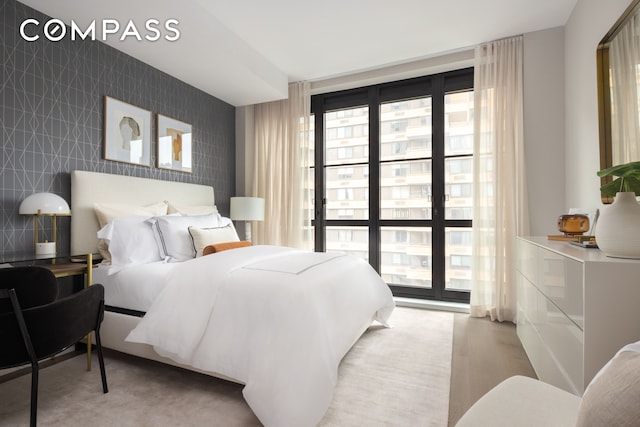 bedroom featuring an accent wall and tile walls
