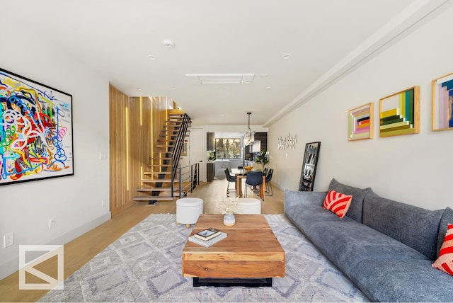 living area featuring stairway and wood finished floors