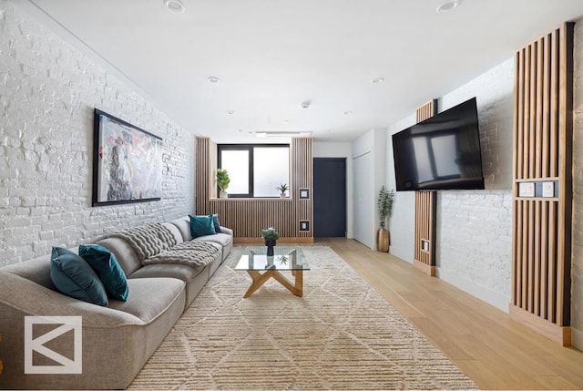 living room with light wood finished floors and recessed lighting