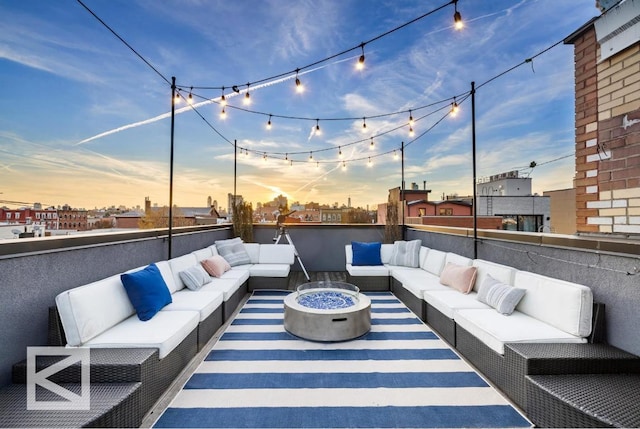 view of patio with an outdoor living space with a fire pit