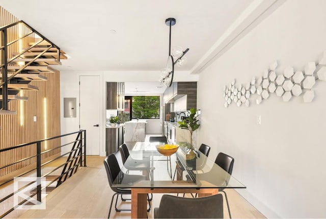 dining room featuring electric panel and light wood-style flooring