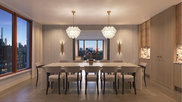 dining room with wallpapered walls, a city view, and a notable chandelier