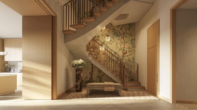 stairway featuring a towering ceiling and baseboards