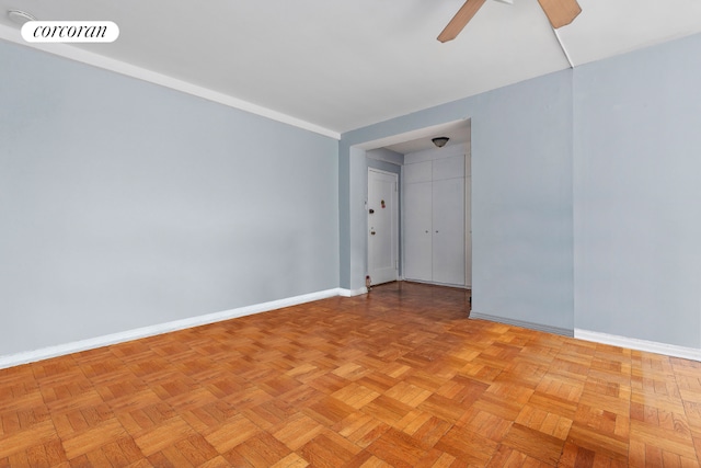 unfurnished room with ceiling fan and light parquet floors