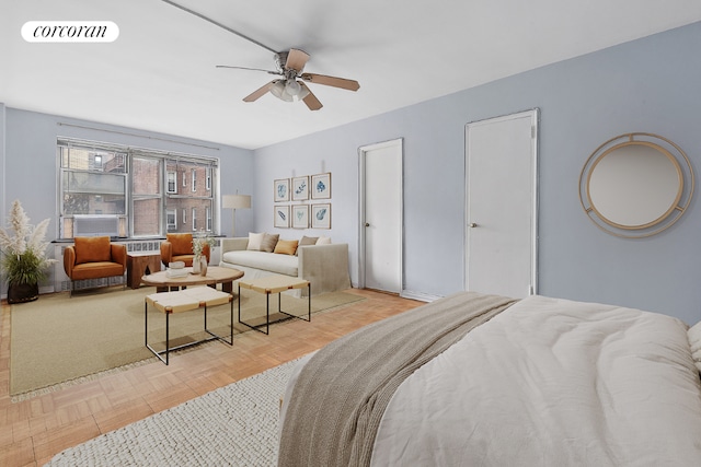 bedroom with ceiling fan and light parquet flooring