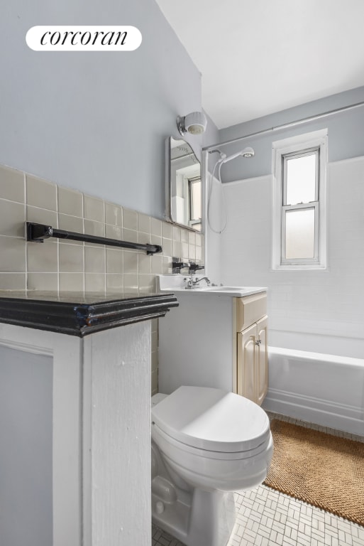 full bathroom with toilet, tasteful backsplash, tile patterned flooring, shower / bathtub combination, and vanity