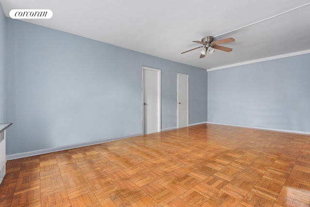 empty room featuring ceiling fan and light parquet flooring