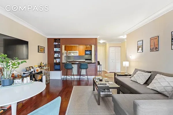 living room featuring ornamental molding and dark hardwood / wood-style flooring