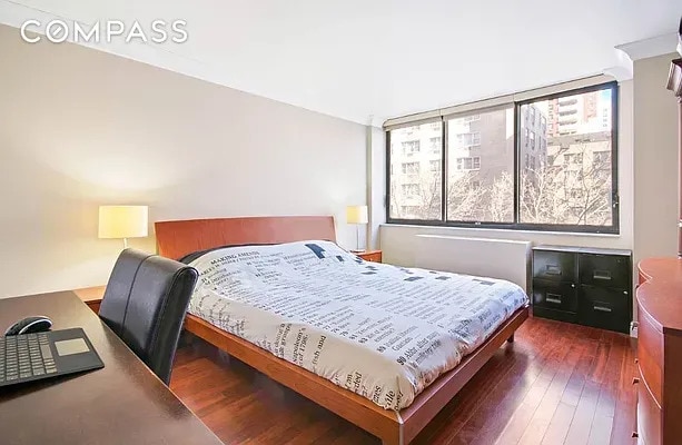 bedroom with dark wood finished floors