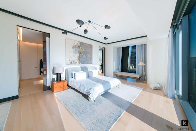 bedroom featuring a chandelier and wood finished floors