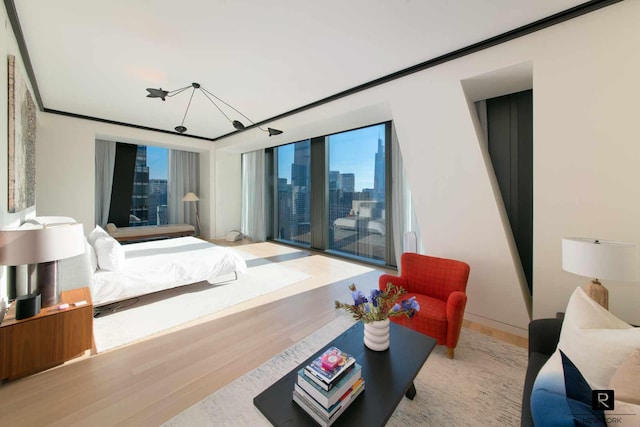 bedroom featuring wood finished floors, a view of skyline, and a chandelier