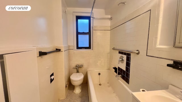 full bathroom with shower / bathtub combination, tile walls, vanity, toilet, and tile patterned floors